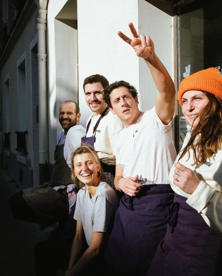 A cheerful catering team standing together outside their workplace