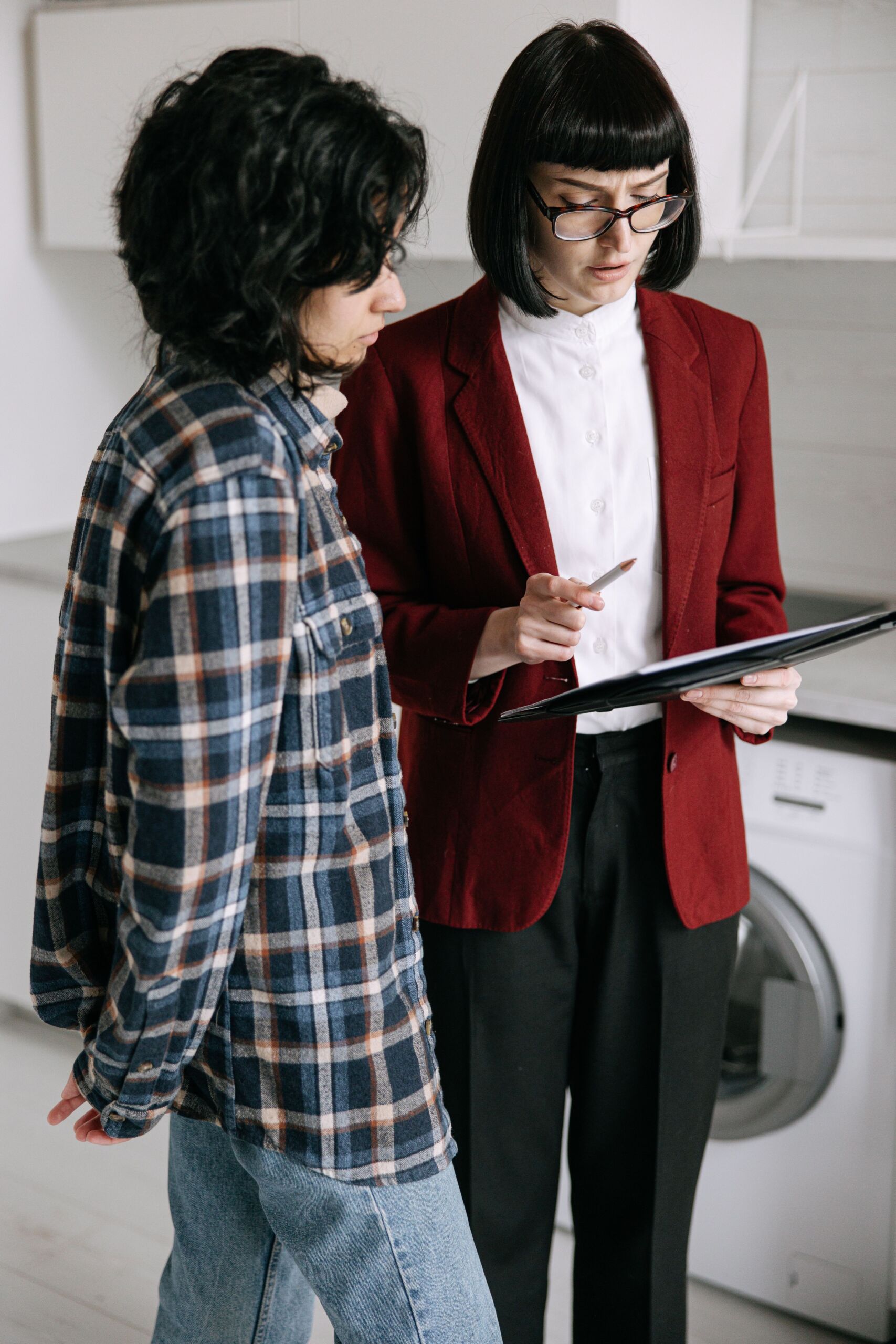 A real estate agent speaking with prospective buyers during an apartment viewing
